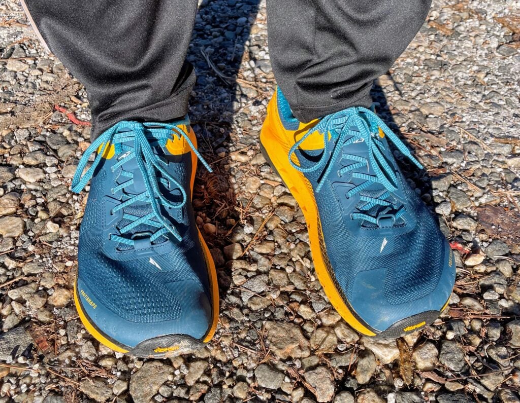 A photo of myself standing on a gravel road in my Alta Olympus shoes.